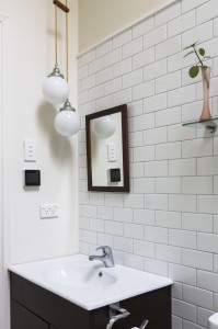 New tiled bathroom with our trademark double opal globes on textile lighting cable.